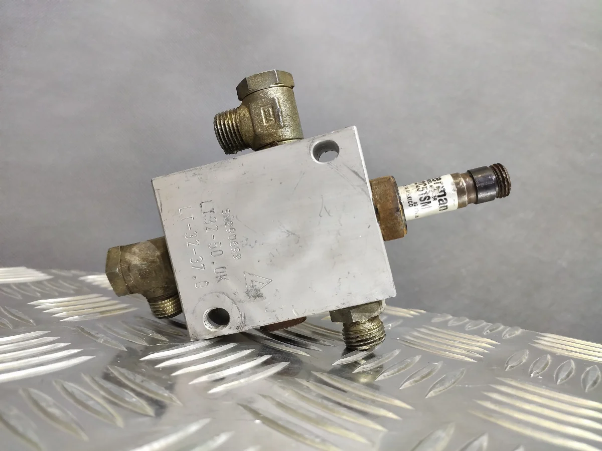 Yellow hydraulic valve with plugged ports