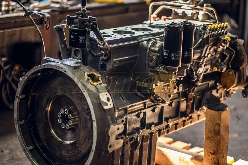 Overhauled diesel engine without cylinder head, showing cylinder bores, oil filters and an inline injection pump