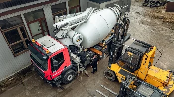 Top view of a CIFA concrete mixer pump truck and a BOSS forklift during service work