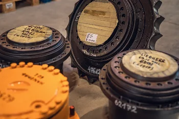 Liebherr R912 and R934 excavator travel gearboxes with track sprocket, labelled for overhaul