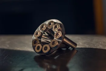 Piston set with slippers in the retainer plate of an axial piston pump lying on a metal workbench